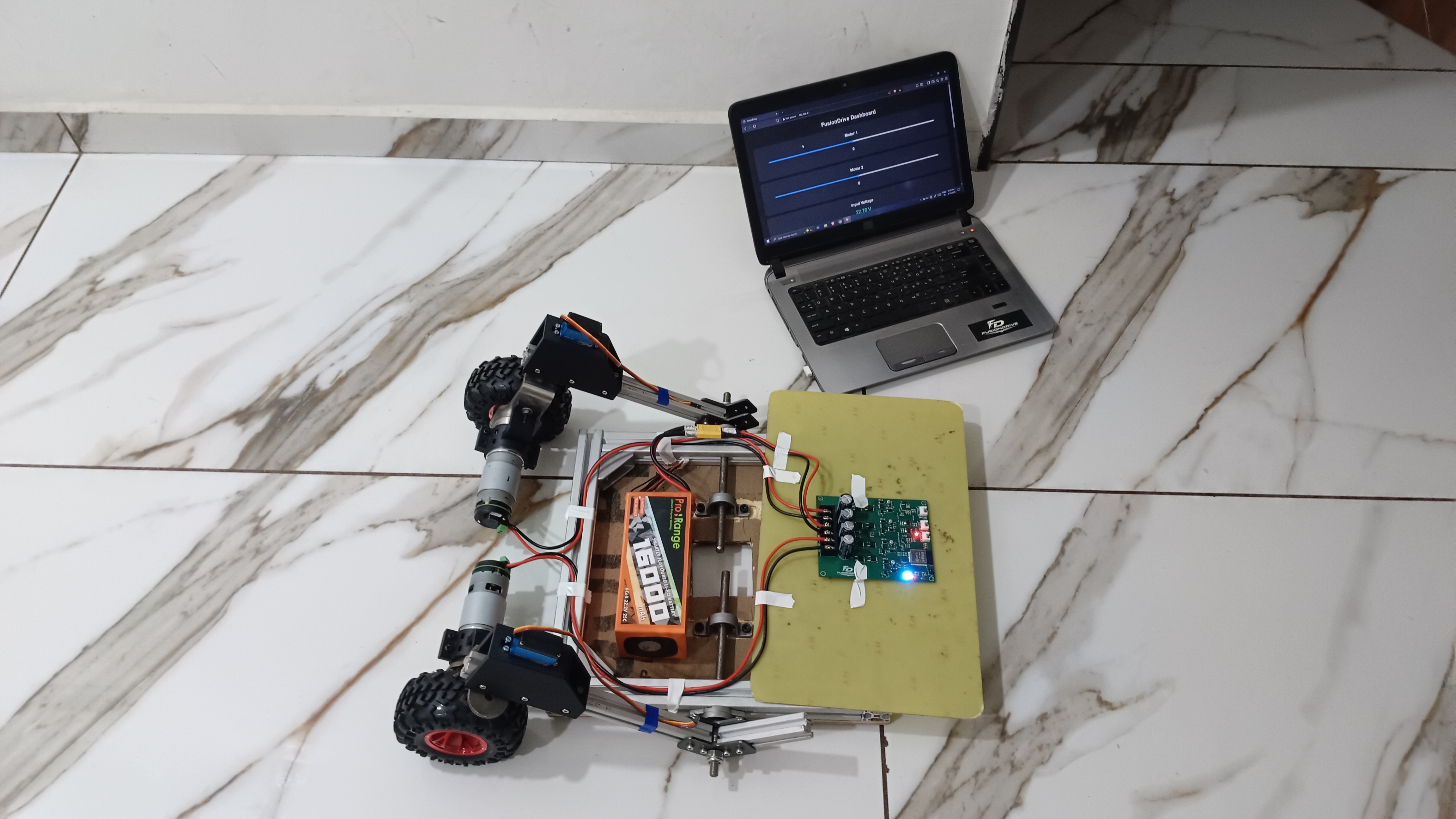 FusionDrive robotic system integration test setup with controller hardware and laptop